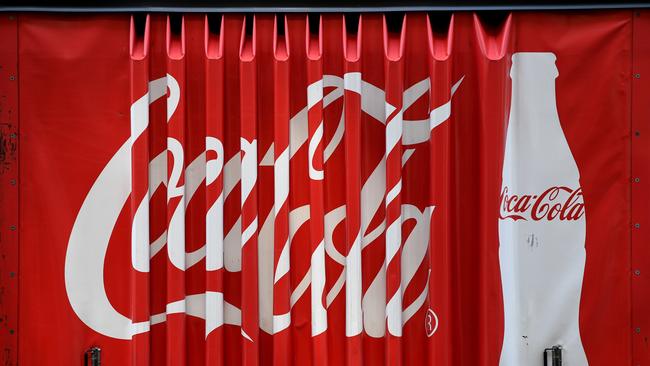 A worker unloads Coca-Cola Amatil products. Picture: Joel Carrett