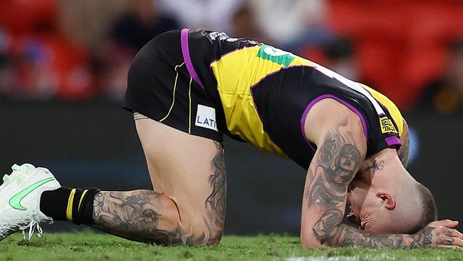 Martin bent over with pain following the bone-crunching collision with Brisbane Lions’ Mitch Robinson. Picture: Michael Klein