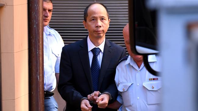 Robert Xie (centre) is escorted to a prison transport vehicle at the NSW Supreme Court in Sydney on Monday, Feb. 13, 2017. Lian Bin "Robert" Xie has been found quilty and been given five life sentences without the possibility of parole for the murder of five members of his wife's family in the bedrooms of their North Epping home in July 2009.(AAP Image/Paul Miller) NO ARCHIVING