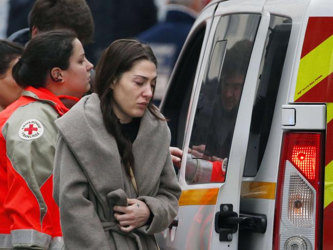 A woman cries outside the headquarters of Charlie Hebdo. Picture: Kenzo Tribouillard