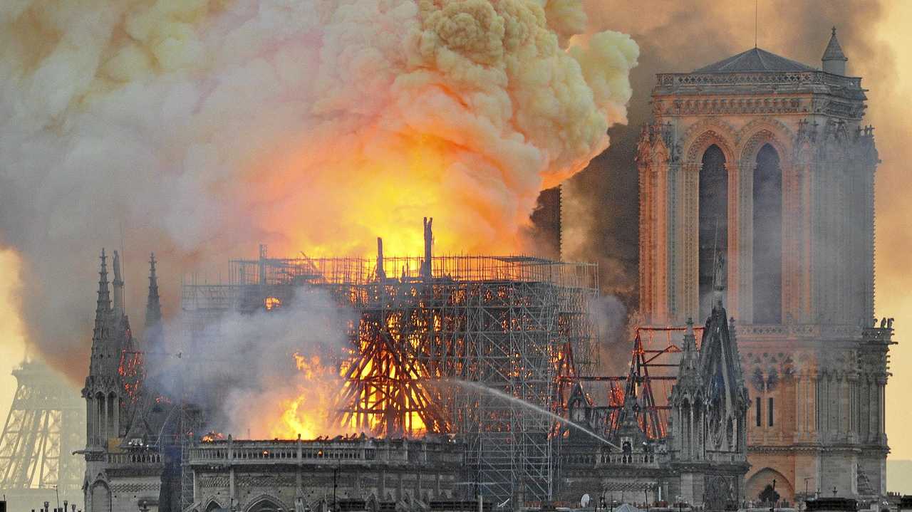 Flames and smoke rise from the blaze after the spire toppled over on Notre Dame cathedral in Paris, Monday, April 15, 2019. Picture: Thierry Mallet