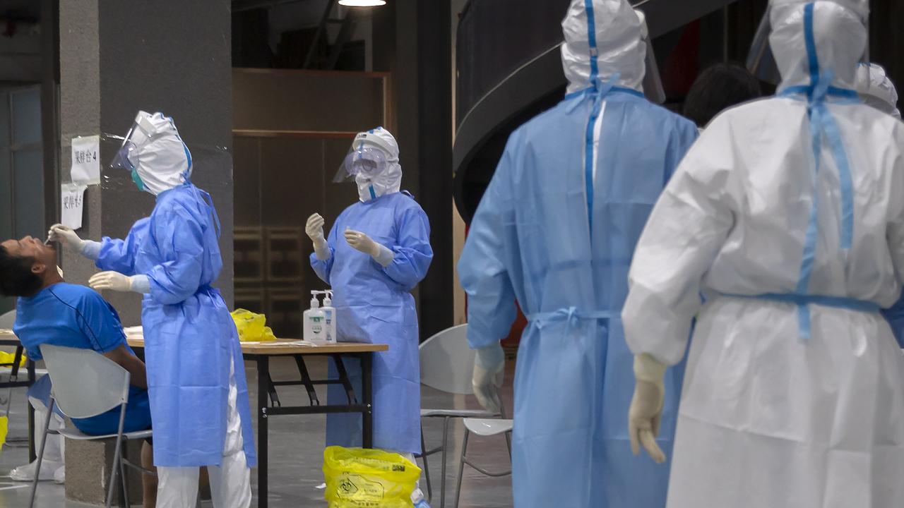 Health workers conducting coronavirus tests in Beijing on Wednesday. Picture: Mark Schiefelbein/AP