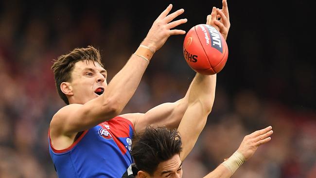 Melbourne’s Jake Lever flies over Carlton’s Zac Fisher during their thumping 109-point win on Sunday. Picture: AAP Image/Julian Smith