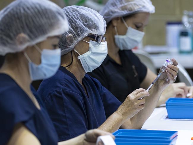 PERTH, AUSTRALIA - APRIL 28: Nurses are seen drawing up doses from a multi-dose vile of AstraZeneca Covid-19 vaccine at Claremont Showground on April 28, 2021 in Perth, Australia. The West Australian Government have opened up two new Vaccine Centres including one at Perth Airport. (Photo by Matt Jelonek/Getty Images)