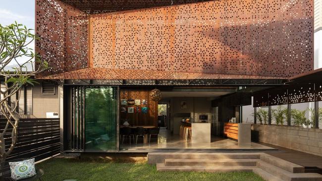 The unique steel screen shields the home from the heat while creating a pattern that gives the home a different look throughout the day.