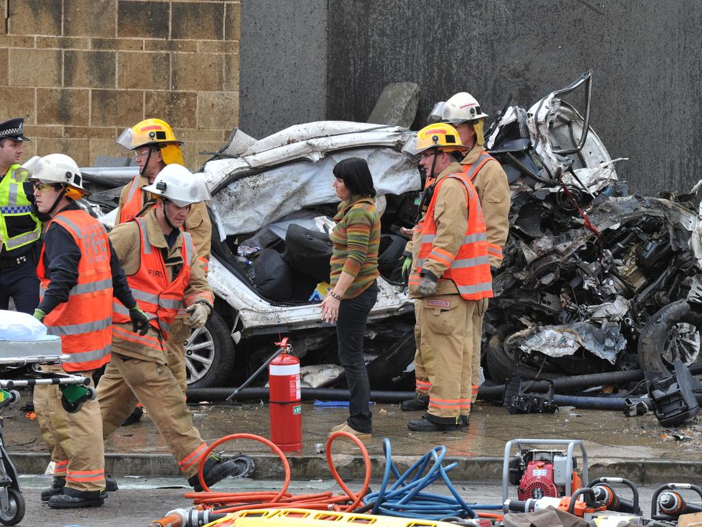 Emergency service workers at the crash on the corner of Glen Osmond and Cross roads. Picture: Roger Wyman