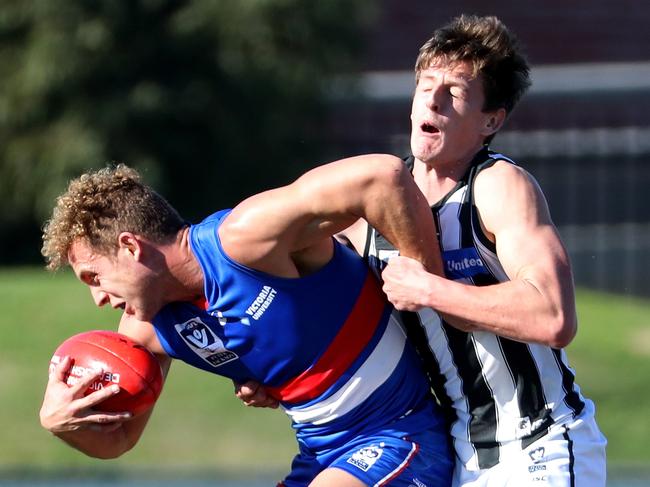 Mitch Wallis of the Bulldogs is tackled by Callan Wellings of the Magpies during the VFL match between Footscray and Collingwood played at Whitten Oval Footscray on Saturday 26th May, 2018.