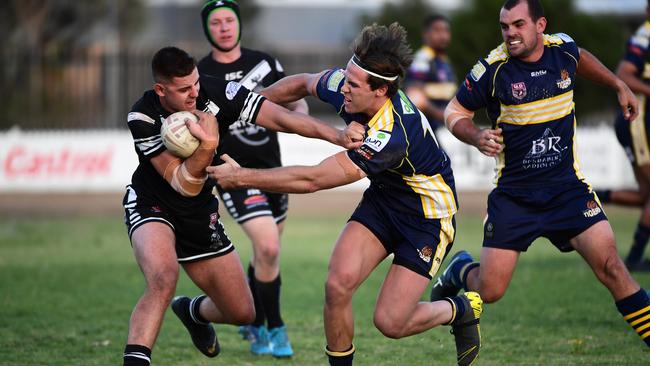 Easts’ Matthew Ross tries to fend off The Waves’ Kristian Colasimone during the preliminary final clash at Salter Oval.