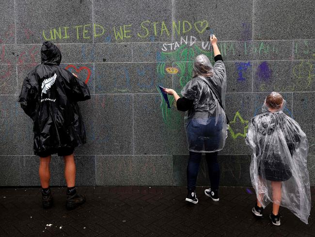 Protesters write messages on the walls of Parliament on the fifth day of demonstrations against Covid-19 restrictions in Wellington, inspired by a similar demonstration in Canada. Picture: AFP