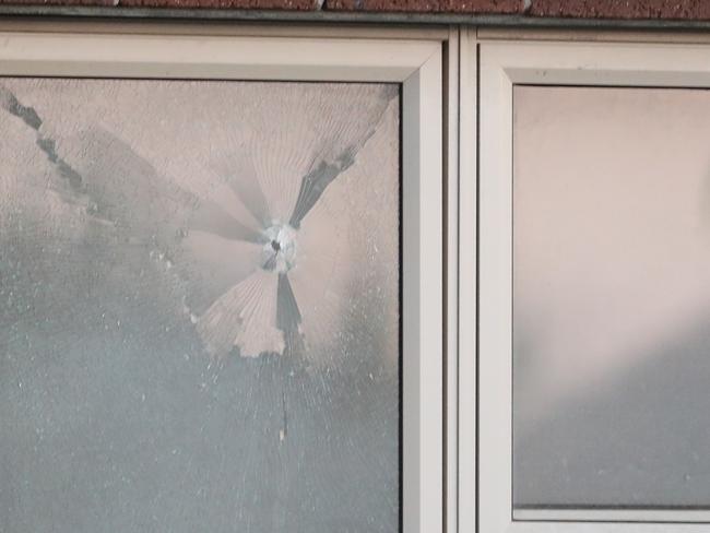 Holes can be seen in the windows where shots have been fired into a Tarneit home. Picture: David Crosling