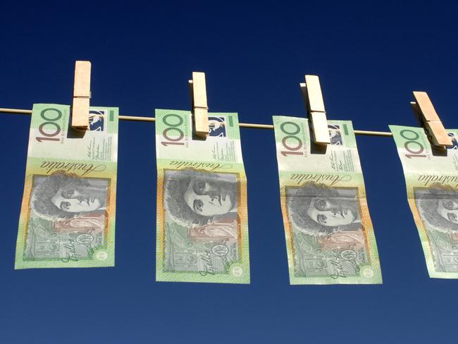 Four Australian $100.00 notes hanging on the line; Australian dollars on clothes line with peg, generic cash