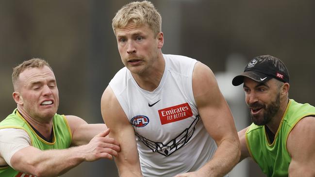 MELBOURNE, AUSTRALIA – SEPTEMBER 20: Billy Frampton of the Magpies is tackled by Tom Mitchell (L) and Steele Sidebottom of the Magpies during a Collingwood Magpies AFL training session at Olympic Park Oval on September 20, 2023 in Melbourne, Australia. (Photo by Daniel Pockett/Getty Images)