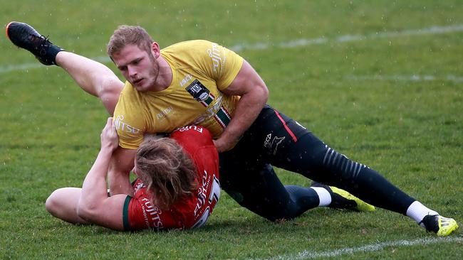 The Burgess brothers, Tom and George, wrestle during a training drill. Picture: Toby Zerna