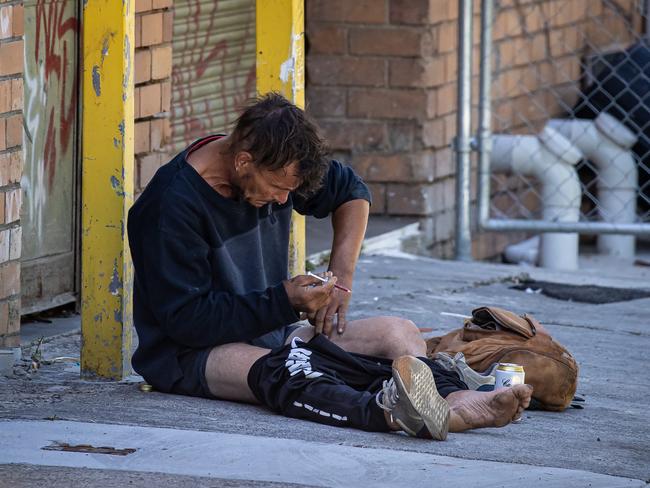 A man injects drugs into his leg in a thoroughfare alley just behind Victoria Street, Richmond and only a few hundred meters from the Safe Injecting Room. Picture: Jason Edwards