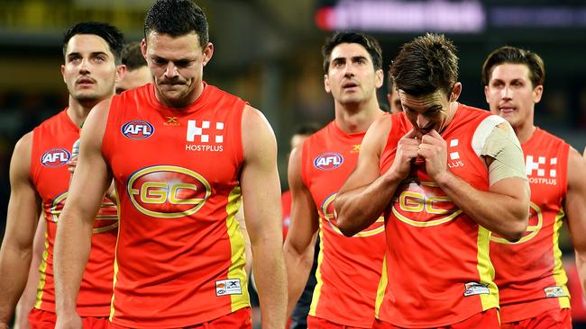 Gold Coast players leave the ground after the club’s massive loss to Port Adelaide. Picture: Getty Images