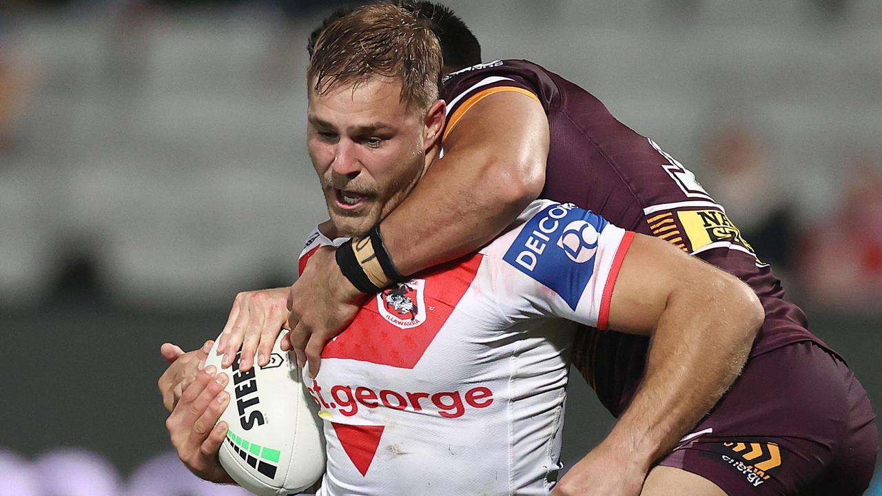 Jack De Belin of the Dragons is tackled.