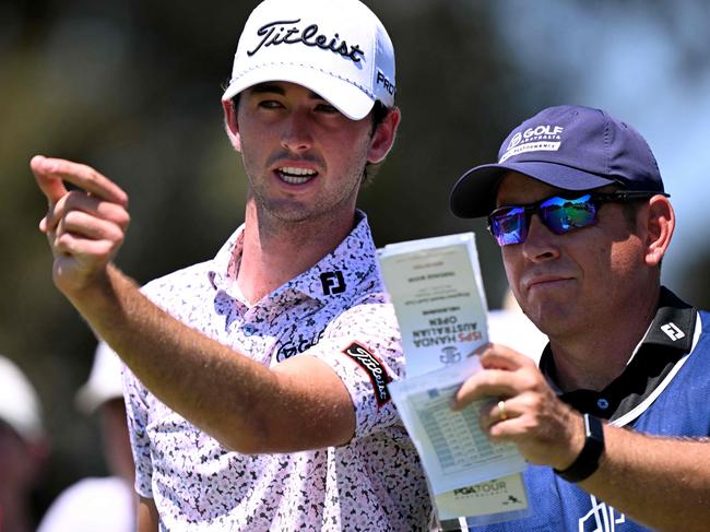 Elvis Smylie talks to his caddie during the Australian Open last year. Picture: AFP