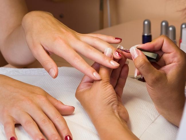 A young woman getting her nails painted during a manicure. Picture: Thinkstock