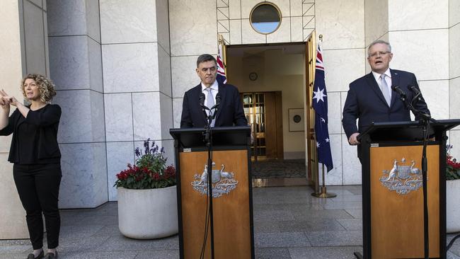 An Australian Sign Language interpreter with Chief Medical Officer Brendon Murphy and Prime Minister Scott Morrison during a CODID-19 press conference at Parliament House in Canberra. Picture: Gary Ramage