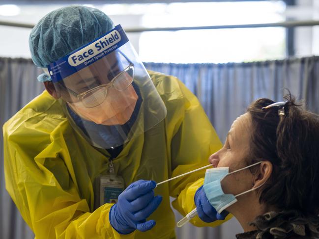 Nurse Cathy Morris in the hot zone of the hospital’s COVID clinic performing a test on a patient. Image: Matthew Vasilescu