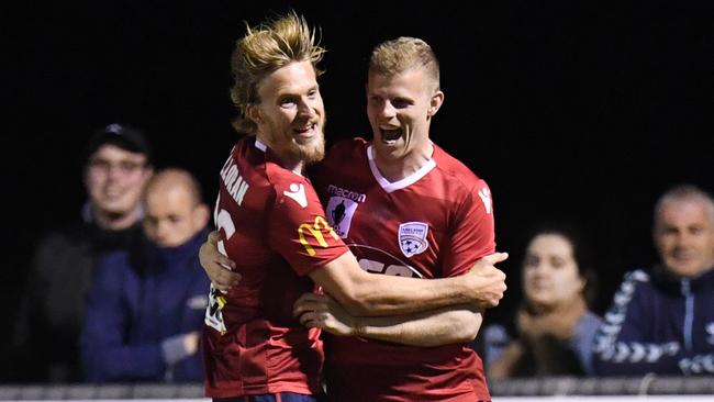 Ben Halloran (left) and Jordan Elsey celebrate after Elsey scored Adelaide United’s second goal on Friday night. Picture: AAP