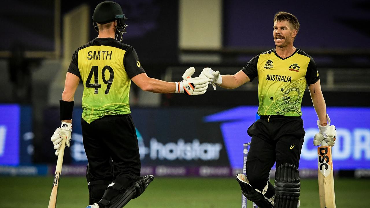 Australia's David Warner bump fists with teammate Steven Smith