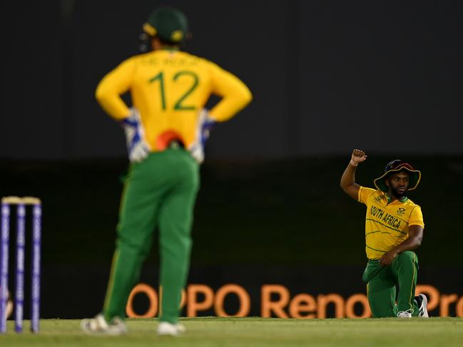 South Africa captain Temba Bavuma takes the knee in Abu Dhabi as Quinton de Kock looks on. Picture: Gareth Copley-ICC/ICC via Getty Images