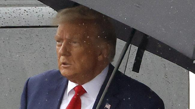 ARLINGTON, VIRGINIA - AUGUST 03: Former U.S. President Donald Trump holds an umbrella as he arrives at Reagan National Airport following an arraignment in a Washington, D.C. court on August 3, 2023 in Arlington, Virginia. Former U.S. President Donald Trump pleaded not guilty to four felony criminal charges during his arraignment this afternoon after being indicted for his alleged efforts to overturn the 2020 election.   Tasos Katopodis/Getty Images/AFP (Photo by TASOS KATOPODIS / GETTY IMAGES NORTH AMERICA / Getty Images via AFP)