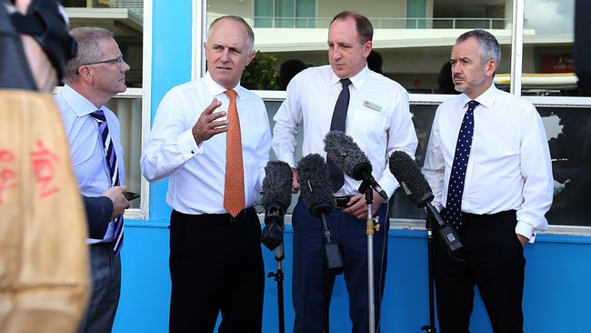 Departing NBN chief architect Tony Cross (far left) talks to Prime Minister Malcolm Turnbull at a Queensland press conference. Picture: Annette Dew