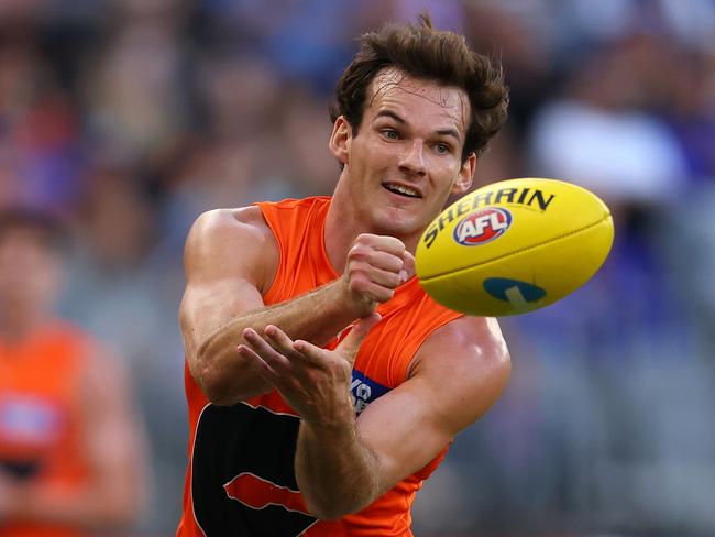 PERTH, AUSTRALIA - MARCH 26: Jack Buckley of the Giants handballs during the round two AFL match between West Coast Eagles and Greater Western Sydney Giants at Optus Stadium, on March 26, 2023, in Perth, Australia. (Photo by Paul Kane/Getty Images)