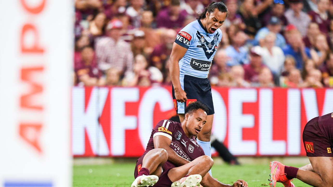 Blues five-eighth Jarome Luai stands over Maroons forward Felise Kaufusi