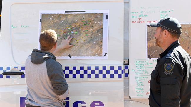 SA Police search teams having a briefing at the homestead. Photo: Naomi Jellicoe