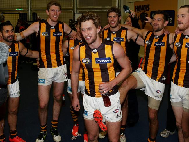 Jonathan O'Rourke takes the middle ground as the Hawks sing the song in 2015.