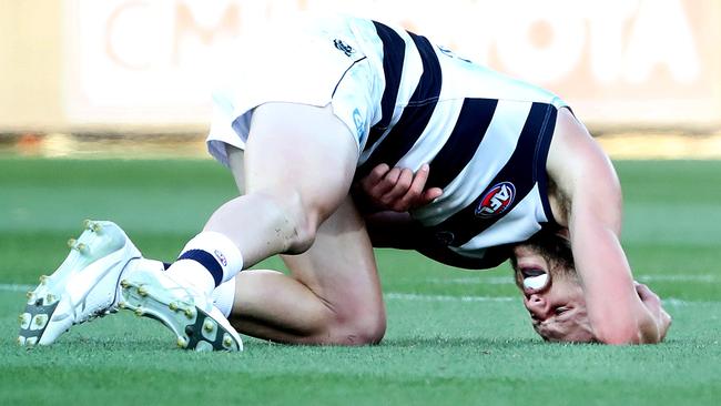 Sam Menegola writhes in pain after injuring himself against the Crows. Picture: Sarah Reed/AFL Photos via Getty Images