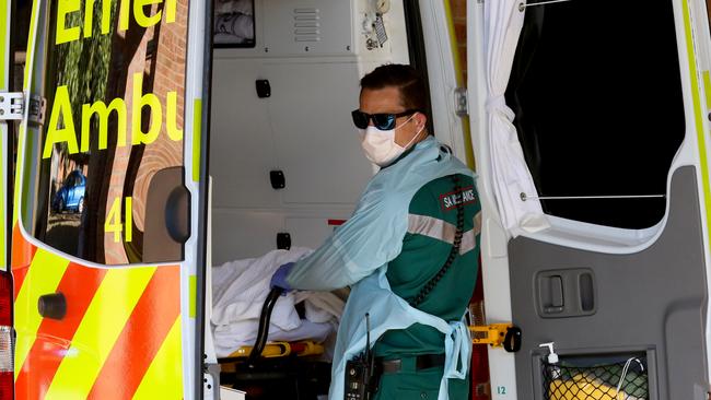 A paramedic wears protective clothing while transporting a patient at the new COVID-19 Clinic at the Mount Barker Hospital in Adelaide on Tuesday. Picture: Kelly Barnes/AAP