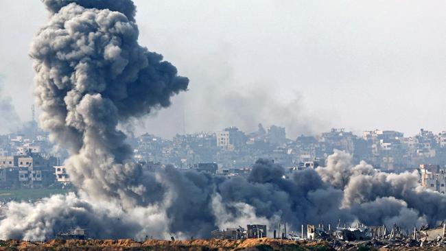 Smoke plumes rise from explosions above destroyed buildings in the northern Gaza Strip on Tuesday. Picture: AFP