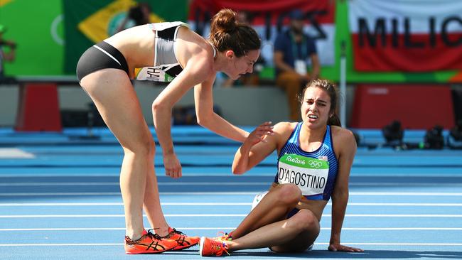 Abbey D'Agostino of the United States (right) is assisted by Nikki Hamblin of New Zealand after a collision during the women's 5000m.