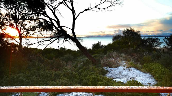 Snow Hobart Sunrise at Lauderdale and snow on the beach.