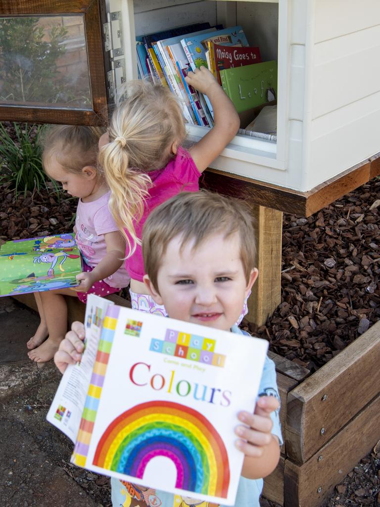 Pre-kindy student Patty Taylor (front) shows off his first library book from the brand new Rosemont Cottage street library. Picture: Nev Madsen