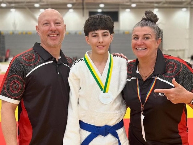 Kaan Hucent with his dad Korgan (left) and trainer Queenie Warhurst (right). Picture: Judo NT.