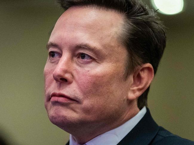 TOPSHOT - Elon Musk listens as US President-elect Donald Trump speaks during a meeting with House Republicans at the Hyatt Regency hotel in Washington, DC on November 13, 2024. (Photo by Allison ROBBERT / POOL / AFP)