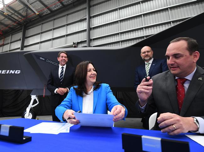 Queensland Premier Annastacia Palaszczuk and Treasurer Cameron Dick sign the agreement with Boeing Defence Australia managing director Scott Carpendale. Picture: NCA NewsWire / Dan Peled