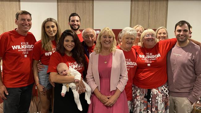 Labor's Kylie Wilkinson (centre, pink jacket) with her family after claiming victory in the key seat of East Hills. Picture: Kirsten Jelinek