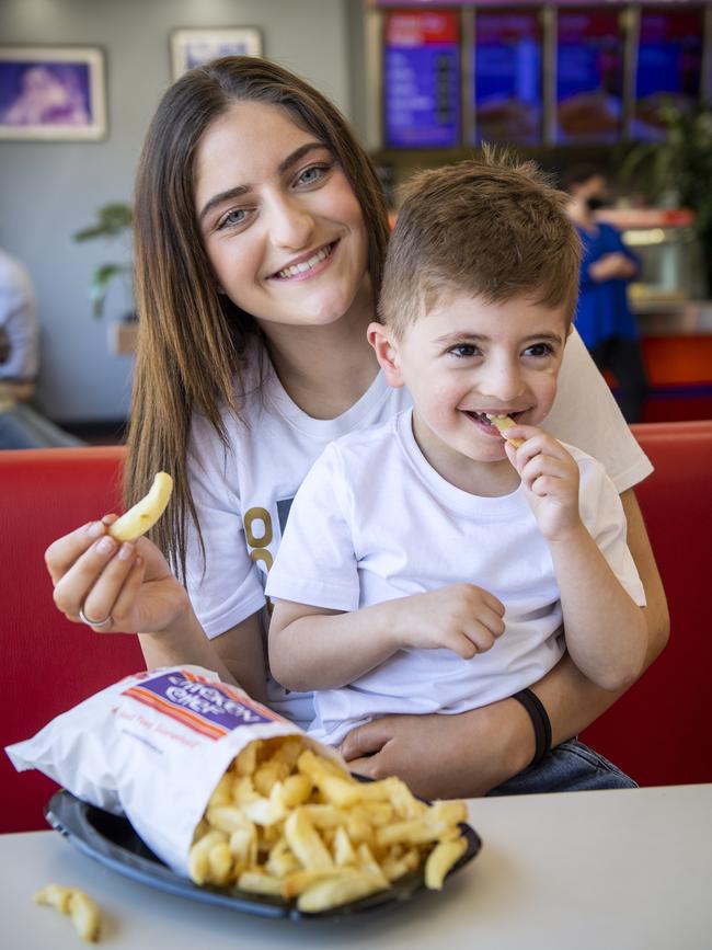 Dimi Christopoulos and Dion Mavrommatis with a bag of the best chips at Chicken Chef, Blair Athol. Picture: Mark Brake