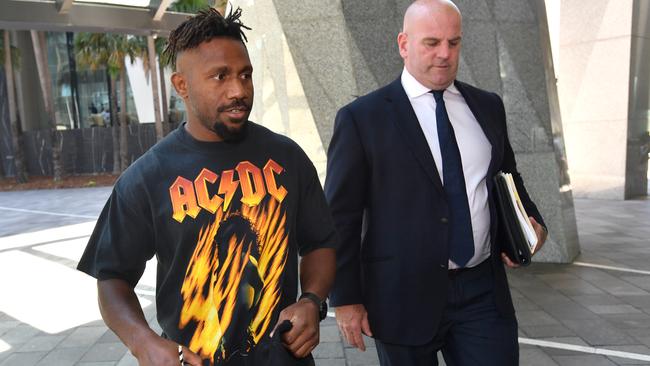 Former Brisbane Broncos player James Segeyaro leaves the ASADA meeting with cap in hand alongside his lawyer Tim Fuller Picture: AAP