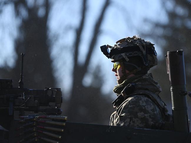 A Ukrainian soldier in an armoured vehicle waits on the west side of the Ukrainian capital of Kyiv. Picture: AFP