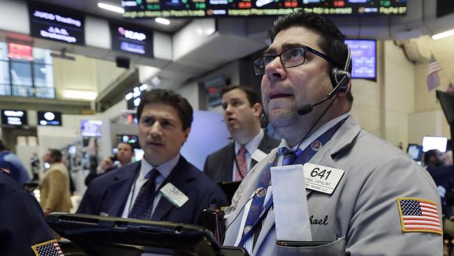 Michael Capolino, right, works with fellow traders on the floor of the New York Stock Exchange, Wednesday, Jan. 20, 2016. Energy stocks are leading another sell-off on Wall Street as the price of oil continues to plunge. (AP Photo/Richard Drew)