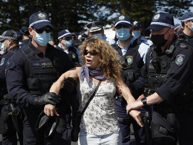 A protester is arrested near Main Beach, Byron Bay after a freedom protest moved from the court house to the beachfront on Saturday, September 18, 2021. Picture: Liana Boss