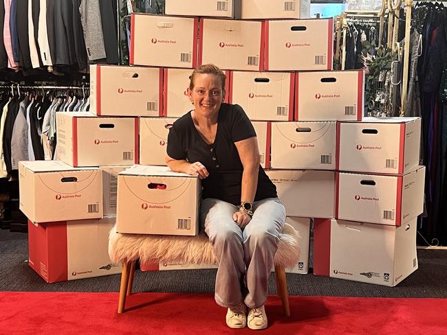 The Formal Project founder Sam Oakes with boxes of suits and dresses to be mailed to kids in remote communities. Picture: Supplied