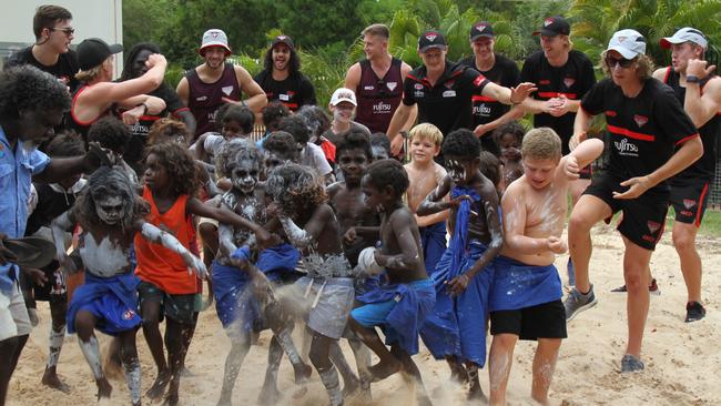 Essendon's first to fourth-year players dance with students at Maningrida. Picture: NATALIE MacGREGOR